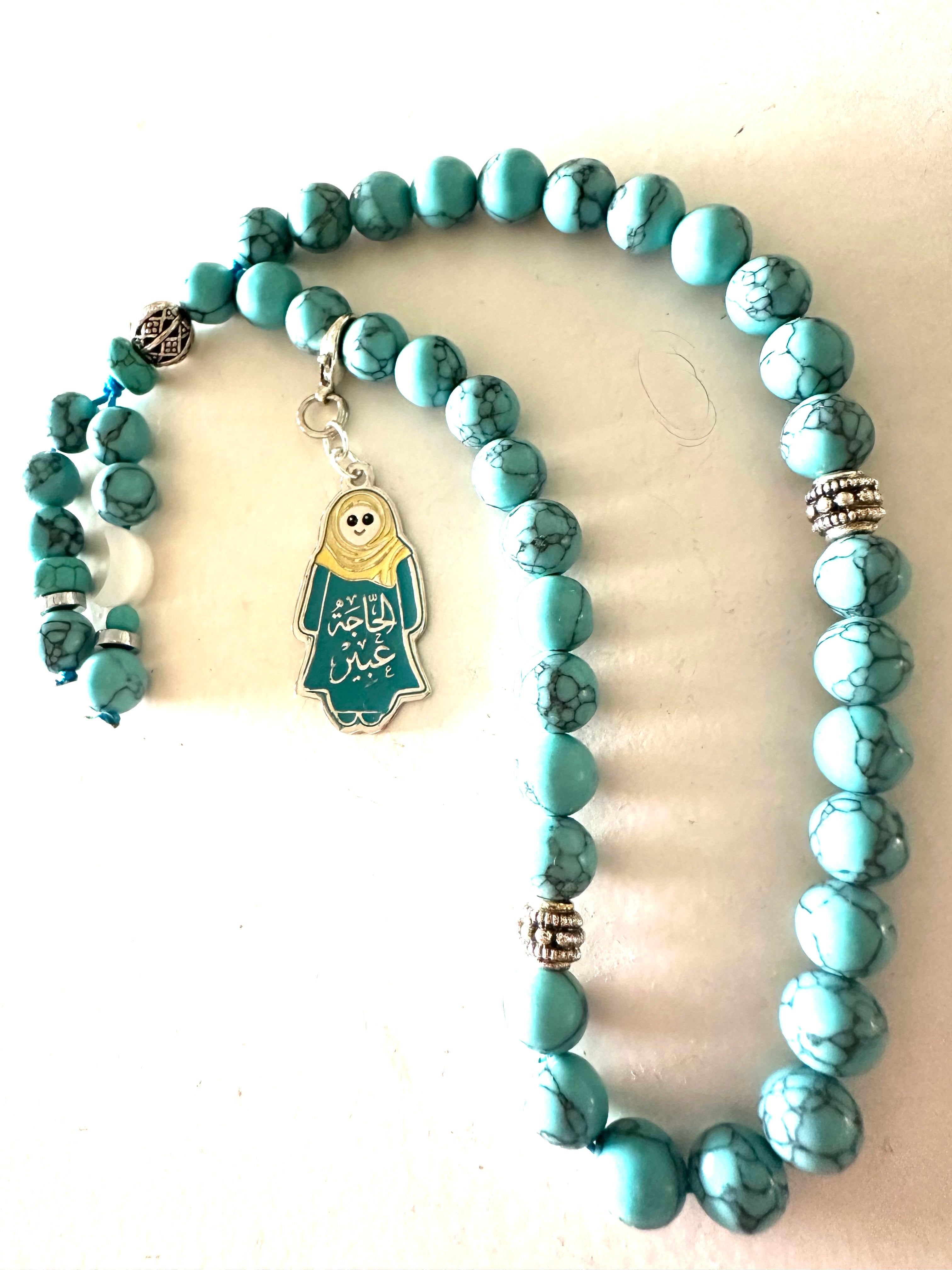 HAGA ABEER  TURQUOISE ABAYA CLIP.