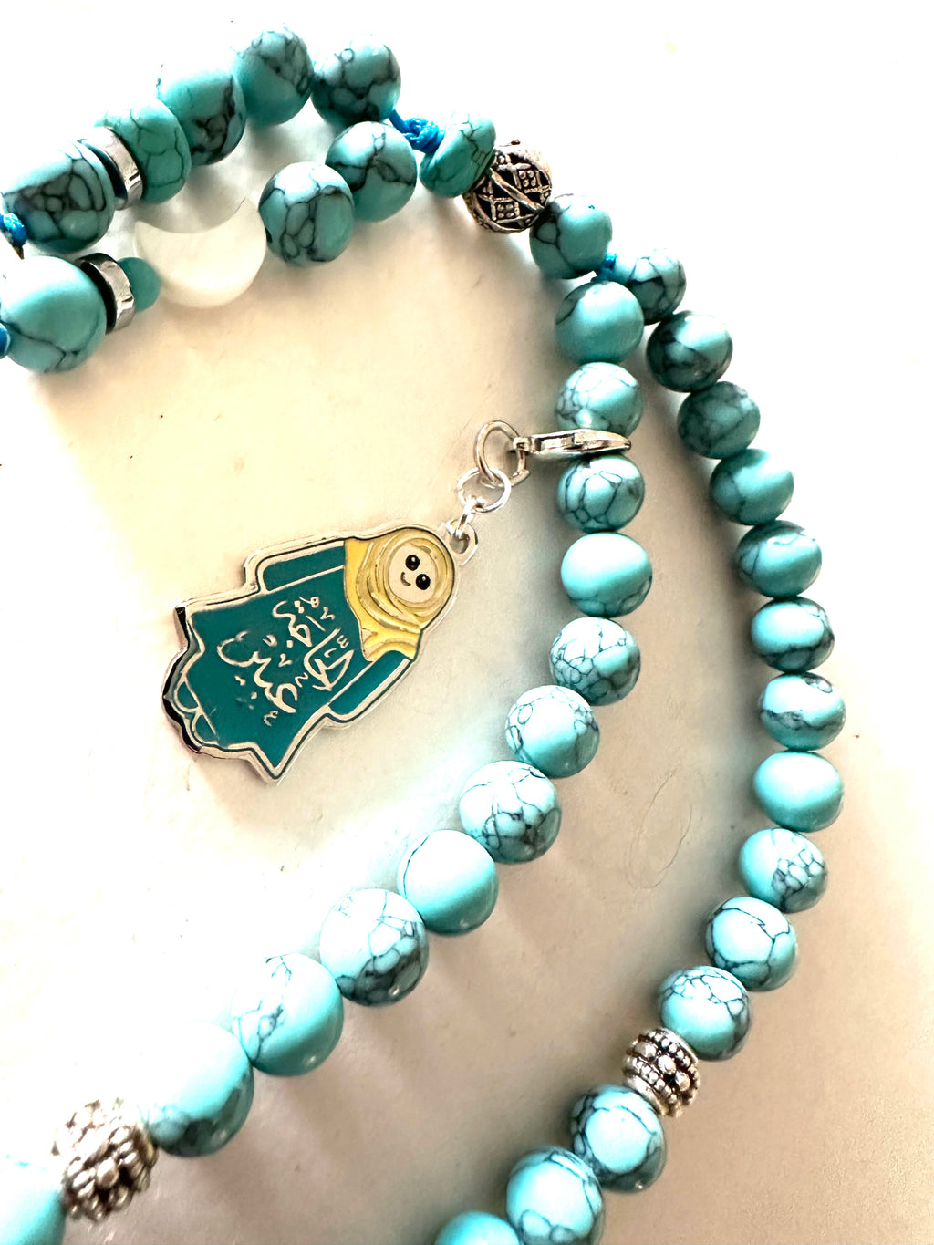 HAGA ABEER  TURQUOISE ABAYA CLIP.